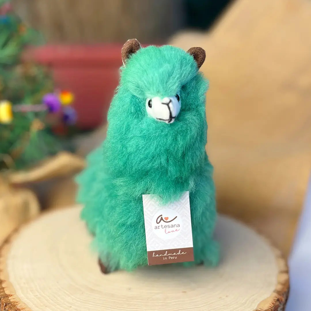 Green plush toy with a label on a woven surface